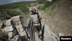 Nagorno-Karabakh -- Ethnic Armenian soldiers walk in a trench at their position near Nagorno-Karabakh's boundary, April 8, 2016
