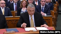Hungarian Prime Minister Viktor Orbán signs the documents in parliament in Budapest declaring him prime minister for the fourth consecutive time on May 16.