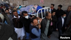 Men carry the body of William Siraj, a priest who was killed by unknown assailants in Peshawar on January 30. 