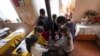 Nagorno-Karabakh - Schoolchildren warm themselves around a stove in the classroom in Stepanakert, December 15, 2022. 