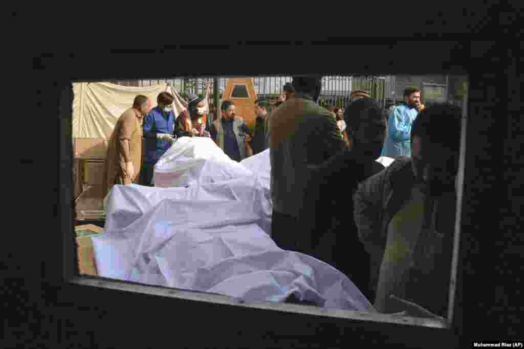 People identify the bodies of relatives killed in the suicide bombing. 