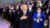 The amendments to the constitution will "nullify" the previous and current terms of Uzbek President Shavkat Mirziyoev (center), allowing him to run for another two consecutive terms. (file photo)