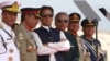 Pakistani Prime Minister Imran Khan (third left) and President Arif Alvi (third right) watch Pakistani Air Force fighter jets perform during a Pakistan Day parade in Islamabad on March 23.
