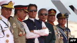 Pakistani Prime Minister Imran Khan (third left) and President Arif Alvi (third right) watch Pakistani Air Force fighter jets perform during a Pakistan Day parade in Islamabad on March 23.
