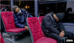 Cheaper than an apartment: two homeless Iranian men find refuge on public transport in Tehran.