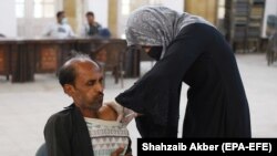 A man receives a dose of the COVID-19 vaccine in Karachi on December 20. 