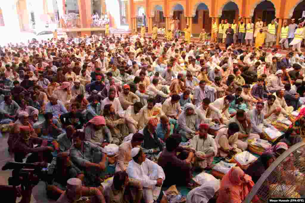 A crowd of men affected by the floods await handouts organized by an Islamist political party in the southern city of Larkana. Pakistani officials say it will take at least two months for the floodwaters to fully recede. 