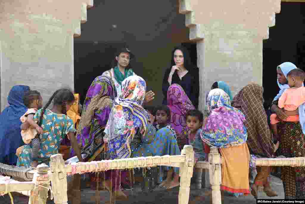 American actress Angelina Jolie (in black) listens through a translator to women in Pakistan's Dadu district after they were displaced by historic flooding that has deluged Pakistan since mid-June. Jolie is a special UN envoy for refugees. She was previously in Pakistan as a special UN envoy after a deadly 2005 earthquake and after flooding in 2010.