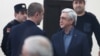 Ex-President Serzh Sarkisian (right) appears in court in Yerevan on February 25.