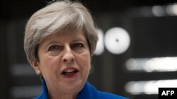 British Prime Minister and leader of the Conservative Party Theresa May makes a statement outside 10 Downing Street in London on June 9.