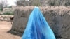 An Afghan woman in a burqa walks through the streets of Kabul in 2008.
