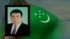 Demonstrators outside the Turkmen Embassy in Moscow hold a Turkmen flag with a black ribbon.