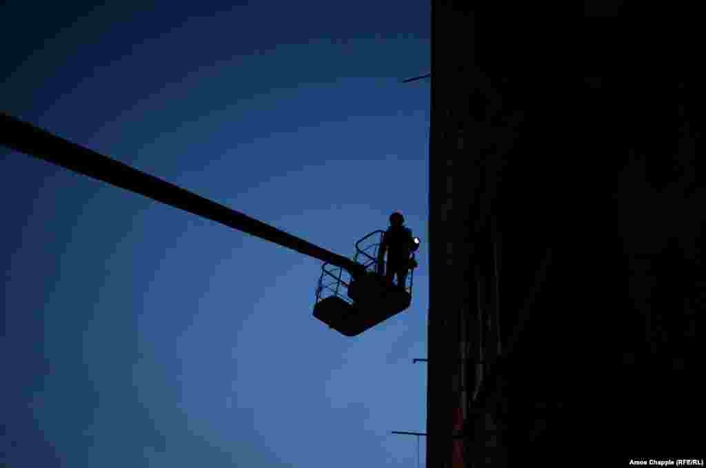 Although told he is out of range of snipers,&nbsp;van Helten waits until after dark to paint the highest, most exposed parts of the mural.