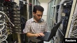 A computer engineer checks equipment at an internet service provider in Tehran in February 2011.