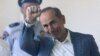 Former Armenian President Robert Kocharian greets supporters during his trial in Yerevan on May 15. 