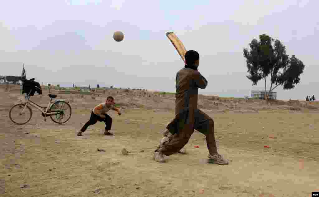Afghan boys play cricket in Jalalabad.