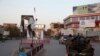 Afghan security forces make their way through a square in the center of Kunduz on October 1.