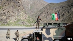 FILE: Afghan army soldiers stand guard on a roadside outside Kabul.