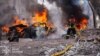 A Ukrainian firefighter battles a blaze following a deadly strike on the northeastern Ukrainian city of Sumy on April 13. 