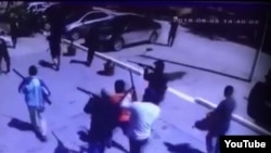 A screen grab of a YouTube video showing masked gunmen on the streets of Aqtobe after the attacks. 