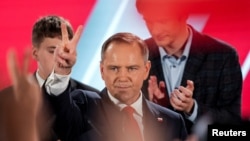Polish presidential candidate Karol Nawrocki, backed by the main opposition Law and Justice (PiS) party, reacts to the exit polls of the second round of the presidential election, in Warsaw, Poland, June 1, 2025