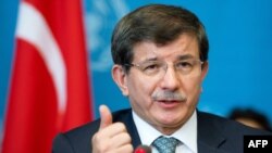 Switzerland -- Turkish Foreign Minister Ahmet Davutoglu gestures during a press conference following a meeting with United Nations High Commissioner for Refugees on September 4, 2013, in Geneva. 