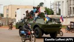 A Russian armored personnel carrier drives in the street during the delivery of armored vehicles to the Central African Republic army in Bangui in 2020.