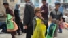 Afghan children sell plastic bags at a market in Kabul