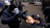 Antigovernment protesters carry an injured man on a stretcher after clashes with riot police on Independence Square in Kyiv on February 20.