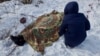 Nadia Volkova leans over the body of her mother, Katya, who was killed during shelling in the eastern Ukrainian city of Avdiyivka on February 1.