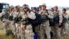 Georgian soldiers carry their gear upon arrival from Iraq at Tbilisi airport on August 11.