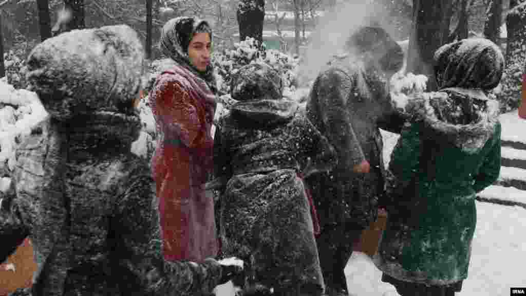 Young people play in the snow in a park in Iran's capital, Tehran.