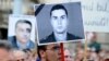 Hungary -- Activists and sympathizers of Hungarian 'Milla' Group lift a photo of Armenian Army Lieutenant Gurgen Margarian (C), beside a picture of Hungarian Prime Minister Viktor Orban (L), in front of parliament building in Budapest, 04Sep2012