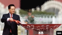 President Hu Jintao lighting the Olympic Torch on Tiananmen Square in Beijing in March