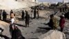 Afghan security personnel gather at the site of a suicide attack at a police compound in Maiwand district of Kandahar province, December 22, 2017