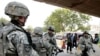 U.S. Army soldiers searching a vehicle in Baghdad on July 31