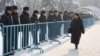 Полиция стоит вдоль металлических ограждений в день акции протеста оппозиции. Алматы, 28 января 2012 года.
