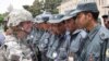A US soldier congratulates Afghan police after training in Kabul