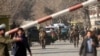 Security forces inspect the site of a suicide attack in the center of Kabul that killed scores of people on January 27.