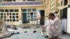 A man sits in a Herat mosque the day after a deadly attack that left at least 33 people dead. 