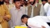 An activist kisses the body of nationalist leader Habib Jalib Baloch, who was shot by gunmen in an attack in Quetta on July 14.