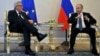 Russian President Vladimir Putin (right) meets with European Commission President Jean-Claude Juncker in St. Petersburg on June 16. The policy document leaves an opening for improved relations between Brussels and Moscow, stating that "the EU and Russia are interdependent."