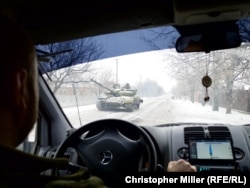 A Ukrainian tank rumbles through the outskirts of Avdiyivka en route to a battlefield position.