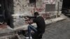 Syria -- A Syrian rebel takes position on a street in the northern city of Aleppo, 03Aug2012