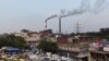 FILE: Smoke billows from two smoke stacks at the coal-based Badarpur Thermal Station in New Delhi, April 6, 2015