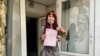 Yelena Gorban shows reporters her wedding certificate on June 23. 