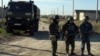 Вооруженные полицейские, участвующие в спецоперации по задержанию подозреваемых в нападении на полицию. Атырау, 21 сентября 2012 года. Фото с сайта "Ак Жайык".