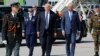 U.S. President Donald Trump (center) walks beside Belgian Prime Minister Charles Michel (right) upon arriving at Brussels airport on May 24.