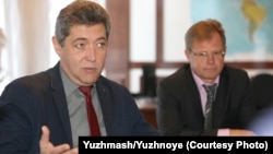 Volodymyr Sokolov (left) and Oleh Lebedev say the Korea report has not hurt Yuzhmash's business.
