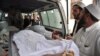 FILE: Volunteers carry a body of a girl killed by a landmine while she collected firewood in the eastern Nangarhar province. 